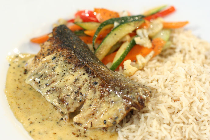 Black cod served with rice and vegetables.