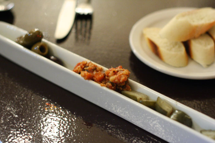 Amuse bouche (olives and antipasto) with French bread at Cassis Bistro in downtown Vancouver.