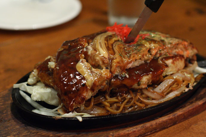 Mixed Seafood Okonomiyaki Japanese pizza served on Yakisoba noodles ($16.50) from Clubhouse Restaurant in Vancouver.