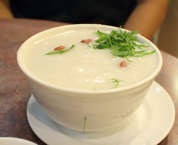 Plain congee garnished with green onion from Congee Noodle House Chinese Restaurant in Vancouver BC Canada.