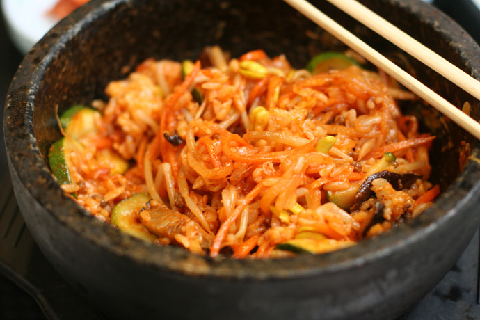Korean Bibimbap dish after mixing the ingredients in the hot stone bowl.
