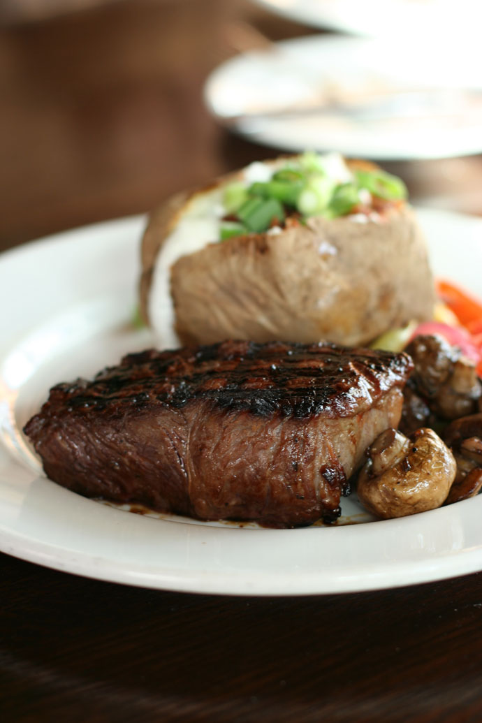 Teriyaki Sirloin steak (medium rare) with Baked Potato and vegetables from the Keg Steakhouse in Vancouver. ($24.95 including Caesar salad)