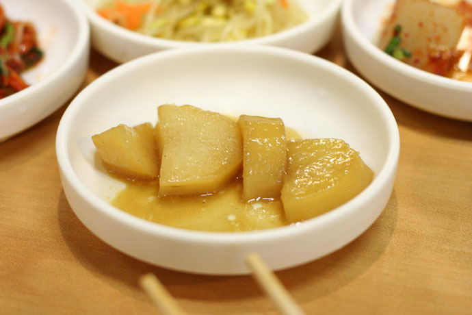 Korean condiments (caramelized sweet potatoes) and chopsticks from Madangcoul Korean Restaurant.