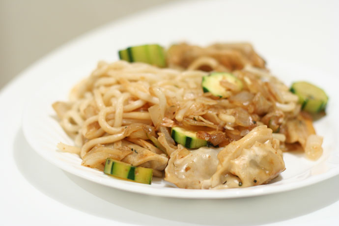 Udon noodles, dumplings, and zucchini with onions, garlic, and white wine.