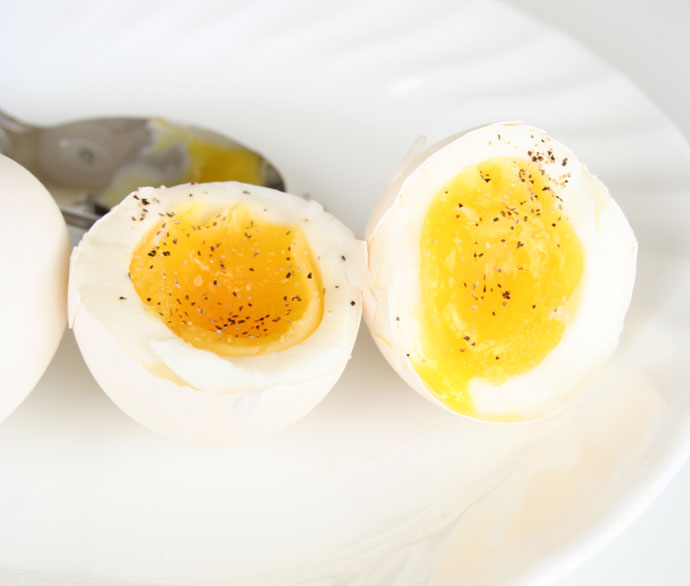 Soft boiled eggs with pepper and salt