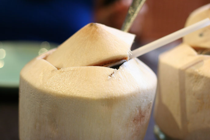 Coconut Juice served in a fresh real coconut (around $4.00) from Tropika Malaysian and Thai restaurant in Vancouver BC Canada.